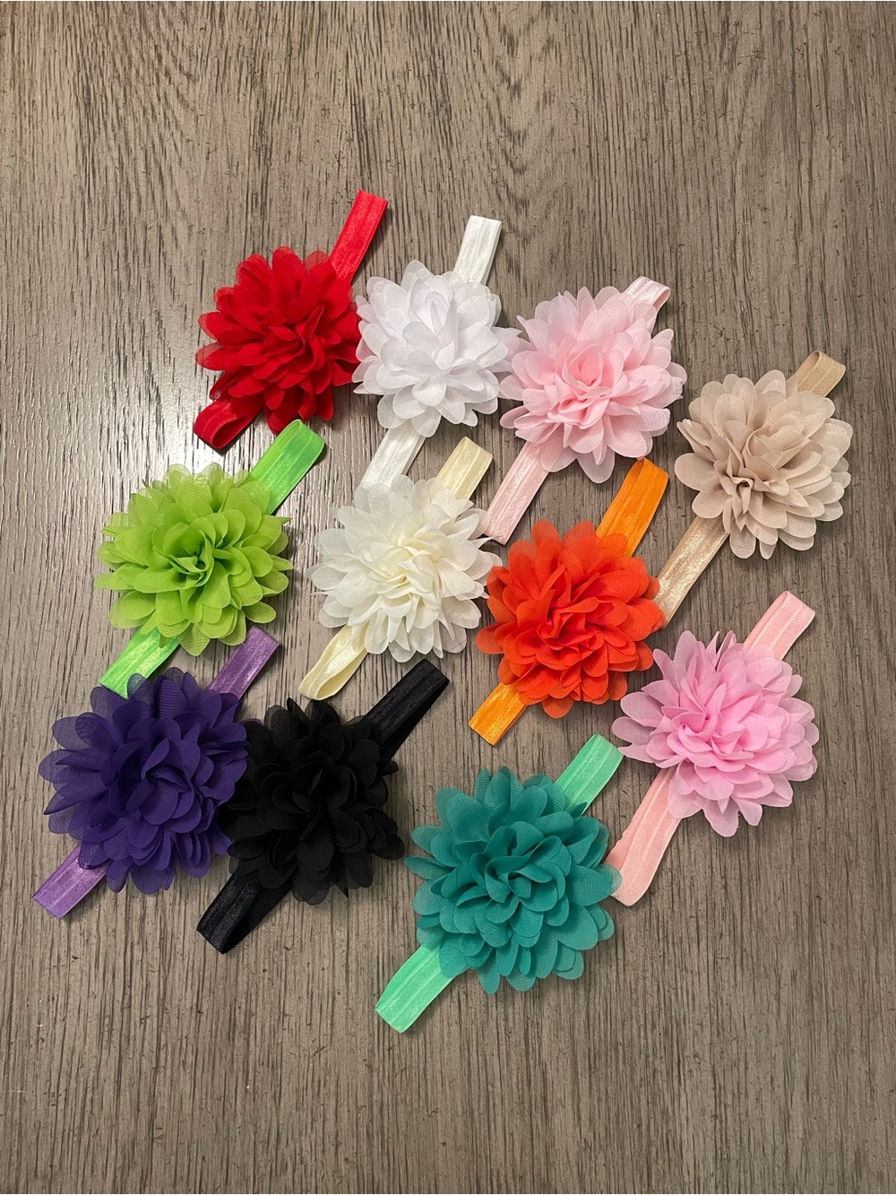 Girlâs elastic floral headbands, 11 assorted colors.